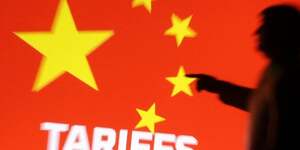 File photo: illustration shows 3d-printed miniature model depicting u.s. president donald trump, chinese flag and word & 34 tariffs 